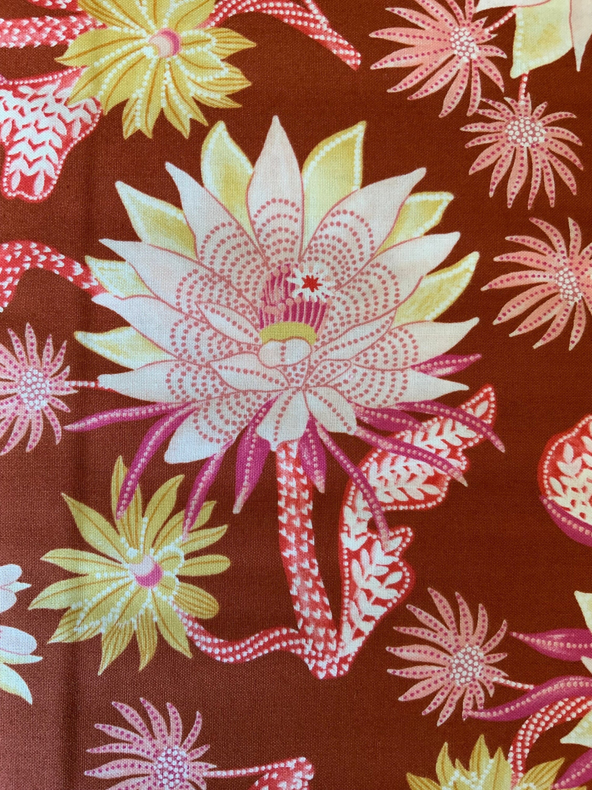 Desert sunrise 90855-32 Rust FIGO FABRICS Flower design with orange, pink, yellow
