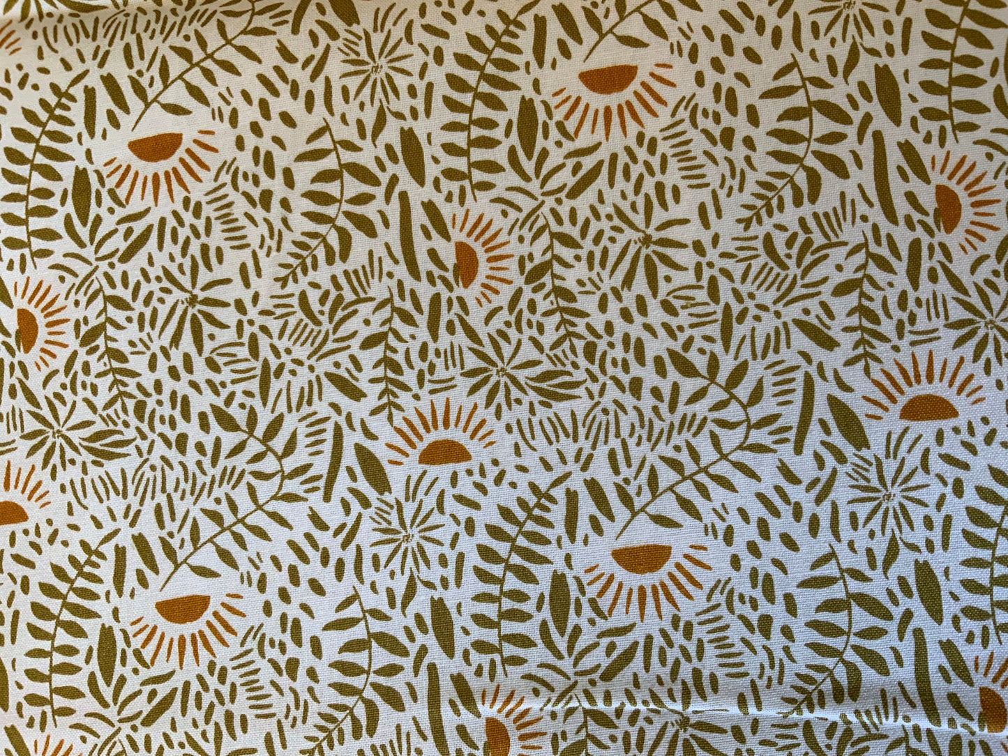 floral-cotton-fabric-green-tan-plants-orange-suns