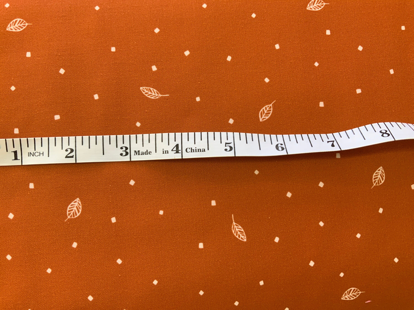 rust-cotton-fabric-savanna-sunset-leaves-print