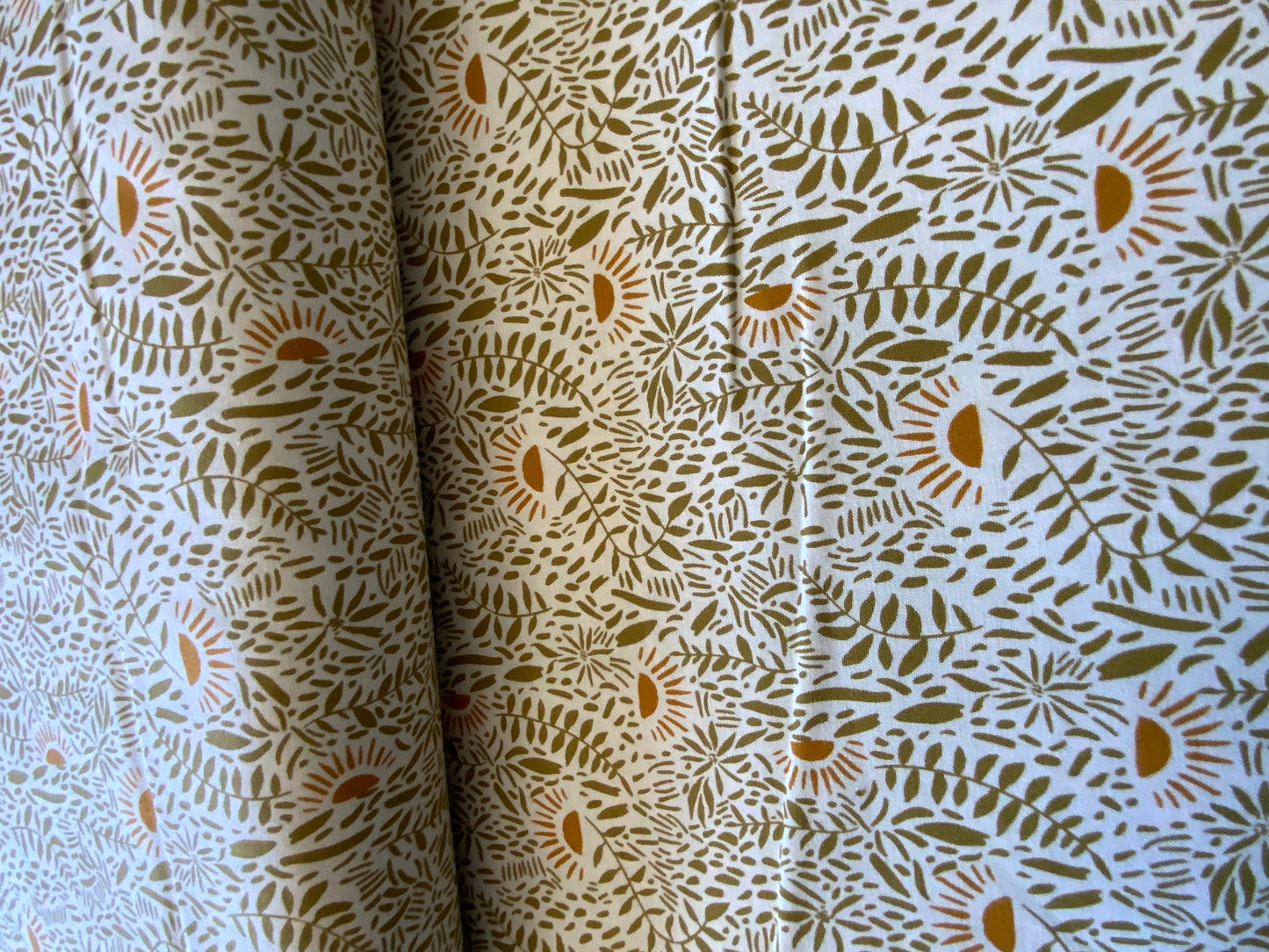 floral-cotton-fabric-green-tan-plants-orange-suns
